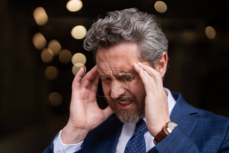 Photo for Sad business man got migraine. Man with strong headache. Stressed, tired businessman from headache. Headache, tiredness and stress, migraine. Headache pain concept - Royalty Free Image