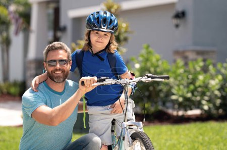 Fathers day. Happy family, men generations. Concept of friendly family and summer lifestyle. Father and son riding a bike in american neighborhood. Parents and children friends. Child first bike