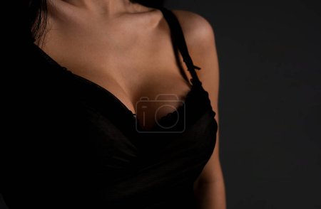Lingerie model. Women breasts. Sexy breas, boobs in bra, sensual tits. Beautiful nude female body. Closeup of sexy girl boob in black bra