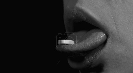 Photo for Woman taking pills, closeup. Sick ill woman holding antibiotic pill. Take medicine. Female tongue with tablet pills. Pain and health concept. Tongue holding pill. White pill in female mouth - Royalty Free Image