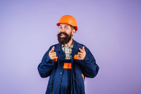 Photo for Funny bearded man in helmet. Crazy fun face of builder with Building equipment and hardhat, safety Helmet. Man in hardhat, Renovation concept. Builder and hard job. Construction man, contractor - Royalty Free Image