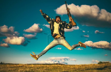 Hunter with shotgun gun on hunt. Crazy hunter on sky background