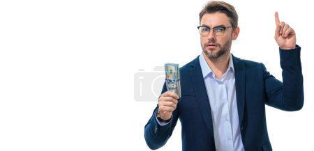 Man holding cash money in dollar banknotes on isolated white banner. Studio portrait of businessman with bunch of dollar banknotes. Dollar money concept. Career wealth business. Cash dollar banner