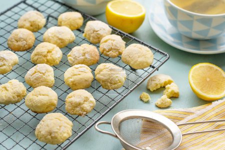 Photo for Lemon crinkle biscuits cookies with powdered sugar served with tea - Royalty Free Image