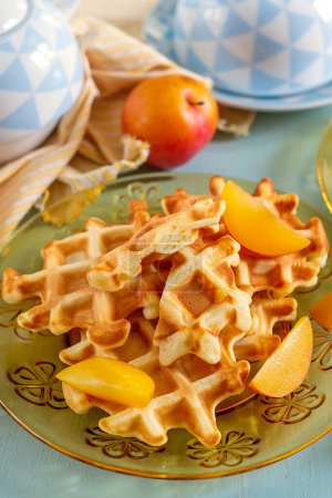 Photo for Sweet Belgian style fluffy classic waffles served with plums - Royalty Free Image