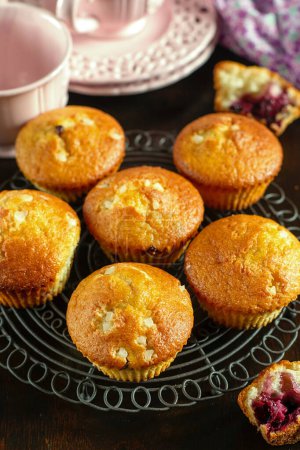 Photo for Homemade sweet fruit muffins with black currant cassis - Royalty Free Image