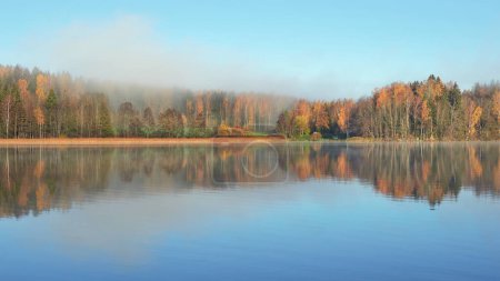 Photo for Fog on shores of Finnish Tuusula lake: morning, autumn, calm. - Royalty Free Image