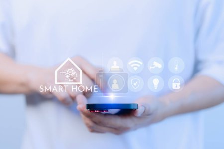 Adult man control technology AI smart home devices using a smartphone or mobile phone with launched application. Internet of Things of smart home automation apps concept.