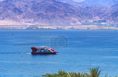 Photo for Excursion on the motorboat at the Red Sea, observing coral reefs, tourist resort hotels, sandy beaches and mountains of Israel and Jordan. Colorful view for Web banner - Royalty Free Image