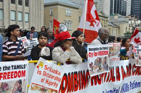 Photo for Toronto, Ontario, Canada - 06/01/2009: Protestors with placard and banners against the Sri Lanka government on the issue on Tamil at the U.S. Consulate - Royalty Free Image