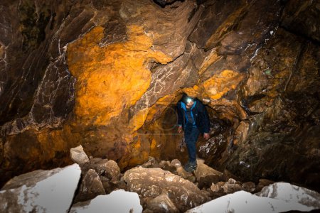 Photo for October 14th 2022, Uttarakhand India. Young explorer with headtorch, venturing deep inside a Himalayan cave in Uttarakhand. Thrilling underground adventure. Stock photo. - Royalty Free Image