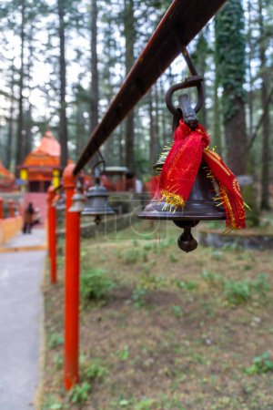 Photo for Bronze Bells with Red Cloths: Spiritual Symbolism at Tarkeshwar Mahadev Temple, Uttarakhand, India - Royalty Free Image