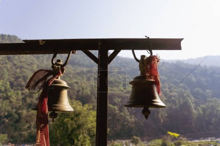 Photo for Bronze Bells with Red Cloths: Spiritual Symbolism at Tarkeshwar Mahadev Temple, Uttarakhand, India - Royalty Free Image