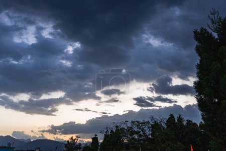Photo for Dawn shot in Dehradun City with Mussoorie hills and majestic cloudscape. Uttarakhand, India - Royalty Free Image