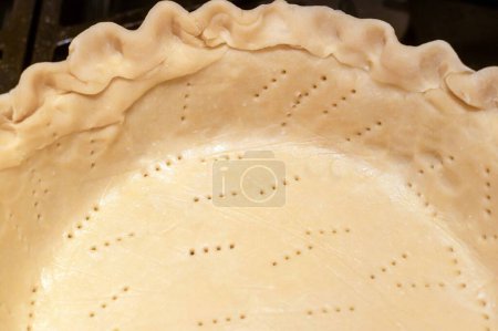 Photo for Perfect homemade pie crust closeup with crimped edge and fork tine marks delicious and welcoming, positive emotion, no people, with copy space. - Royalty Free Image