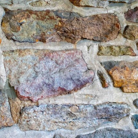 Piedras coloridas con textura áspera en la hermosa pared colonial americana hogar de Pensilvania. gran fondo
