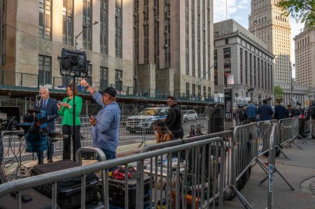 Photo for New York, NY, USA 05-13-2024 News crews lined up in front of 100 Center Street courthouse during Trump hush-money trial. Jorge Ramos and Ilia Calderon with Univision team camera crew in foreground. - Royalty Free Image