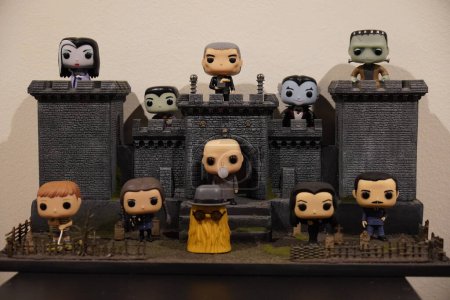 Photo for Horizontal shot of a funko pop diorama of the adams family outside a castle in gray and black colors. - Royalty Free Image
