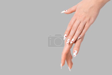 Photo for Female manicure two hands minimal gel polish white long nails and red hearts desing gray isolated background. Beauty spa, Valentine's Day, love concept - Royalty Free Image
