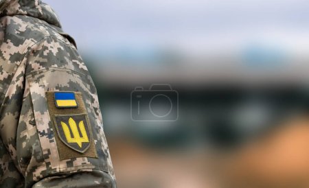 Ukrainischer Soldat in Armee und Flagge, Wappen mit goldenem Dreizack auf uniformiertem Hintergrund. Ukrainische Streitkräfte.