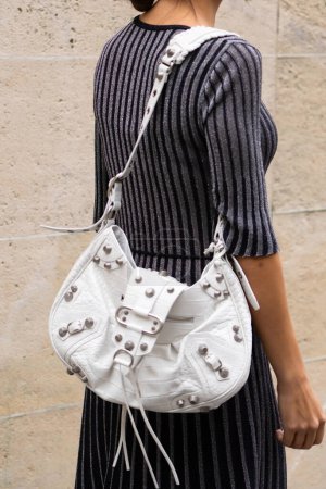Photo for Paris, France - October, 3, 2022: woman wears white Le Cagole embossed shoulder bag from Balenciaga and dress from Stella McCartney, street style details. - Royalty Free Image