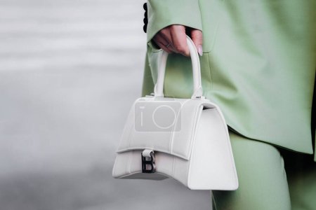 Photo for Milan, Italy - February, 27, 2022: woman wears white Balenciaga Hourglass tote bag, street style details - Royalty Free Image