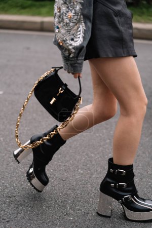 Photo for Milan, Italy - February 24, 2023: fashioner wearing shoulder bag and metallic platform boots from Gucci. Fashion blogger outfit details, street style - Royalty Free Image