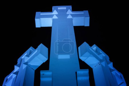 Three crosses monument at night with blue light in Vilnius, Lithuania, on the Hill of Three Crosses