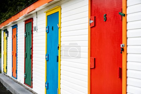 Photo for Colourful doors along a boat shed building near the harbour in Dildo Newfoundland Canada. - Royalty Free Image