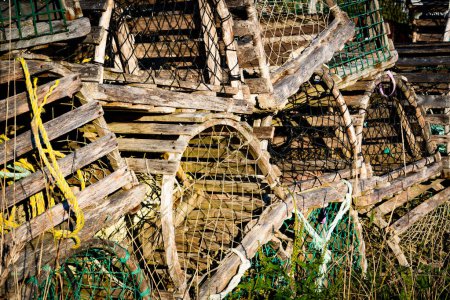 Foto de A stack of wooden lobster traps with netting for commercial fishing in Newfoundland Canada. - Imagen libre de derechos