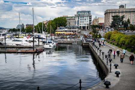 Photo for Victoria British Columbia, July 15 2023:  Harbour view of the down town Inner Harbour with tourists sightseeing along the waterfront. - Royalty Free Image