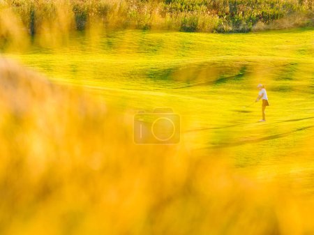 Photo for Grass in front of woman playing golf - Royalty Free Image