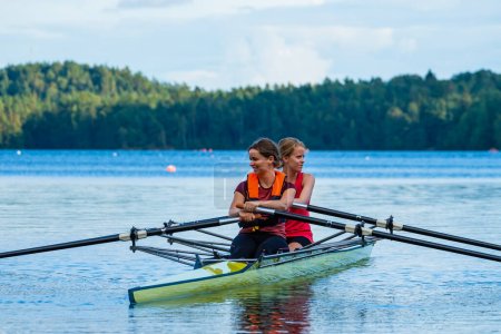 Photo for Pair of Womans rowing on lake - Royalty Free Image