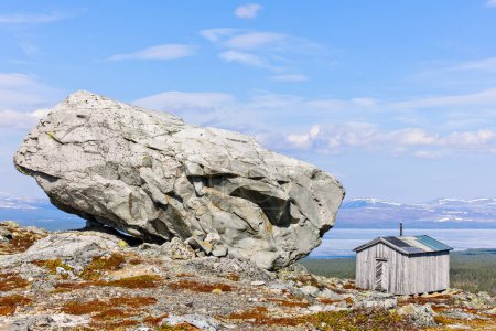 Photo for Remote hut by large rock, Hedmark fylke, Norway, Europe - Royalty Free Image