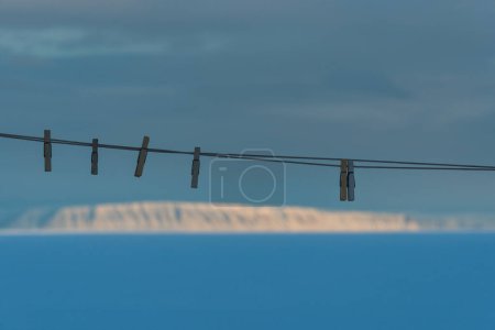 Foto de Clavijas en la línea de lavado en frente de paisajes de montaña, Groenlandia. - Imagen libre de derechos