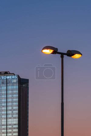 Photo for Street lamps in front of skyscraper - Royalty Free Image