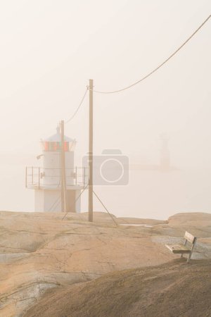 Photo for Lighthouse at coast in mist. Sweden - Royalty Free Image