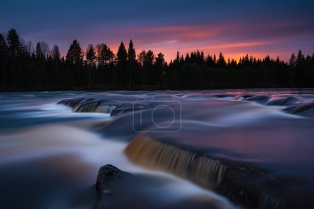 Photo for Misty water rushing over rocks at sunset - Royalty Free Image