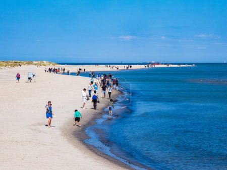Photo for SKAGEN, DENMARK - MAY 20, 2023: A perfect summer day on the beach - a large group of people enjoying the beauty and serenity of nature, with an endless sky meeting vast blue ocean waters. - Royalty Free Image