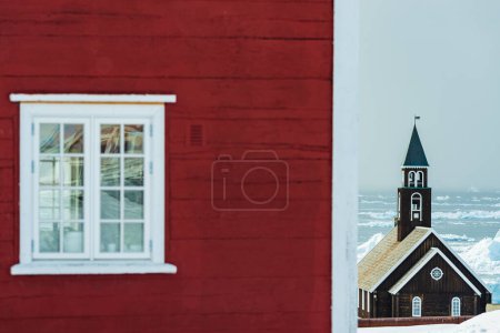 Photo for Red house in front of church - Royalty Free Image