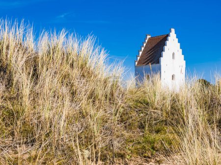Photo for Old church in Skagen among land and prairies with blue sky. - Royalty Free Image