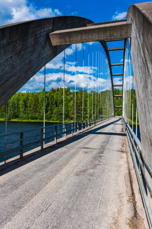 Photo for Old road bridge over river in Sweden with blue sky and clouds. - Royalty Free Image