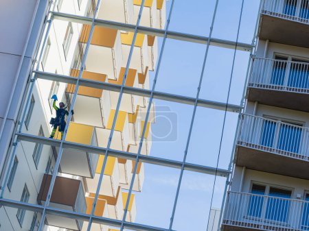 Photo for Window cleaner hanging on ropes against an building - Royalty Free Image