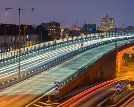 Photo for Illuminated city overpass in the evening with light trails - Royalty Free Image