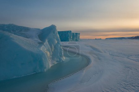 Photo for Iceberg on frozen sea at sunrise - Royalty Free Image