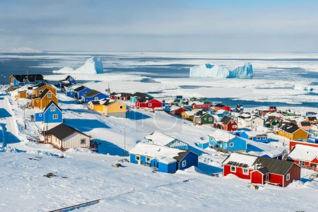 Village overlooking sea with icebergs
