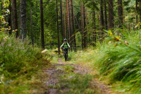 Photo for Young boy cycle mountain bike in forest - Royalty Free Image