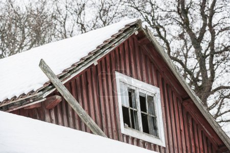 Winter scene with snow-covered roof on barn