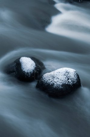 Téléchargez les photos : Rivière glacée avec eau courante et rochers enneigés en hiver. - en image libre de droit