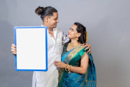 Photo for Indian couple holding gold jewelry, ornaments - Asset or Gold Loan concept. Indian couple looking each other with jewelers in hand - Royalty Free Image